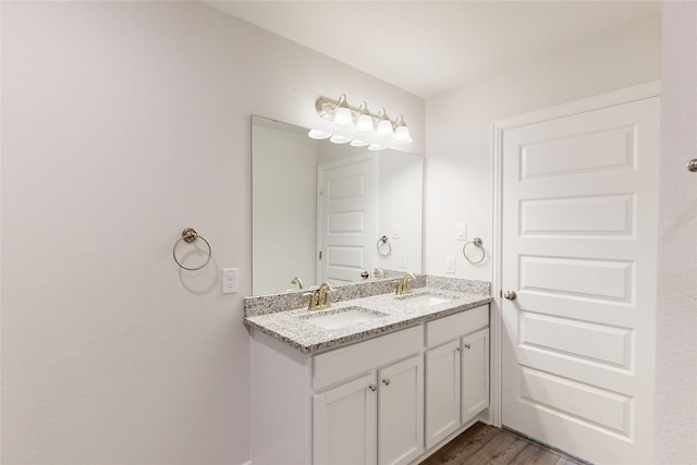 19814 Paros Island Dr, Hockley, TX 77447 - full bathroom with double vanity and wood finished floors
