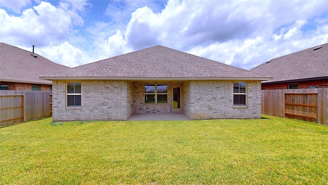 19814 Paros Island Dr, Hockley, TX 77447 - rear view of house featuring a fenced backyard, brick siding, and roof with shingles