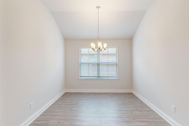 19814 Paros Island Dr, Hockley, TX 77447 - spare room featuring a chandelier, light wood-style flooring, and vaulted ceiling