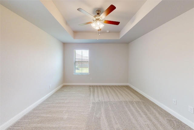 19814 Paros Island Dr, Hockley, TX 77447 - empty room with a tray ceiling, light carpet, and ceiling fan