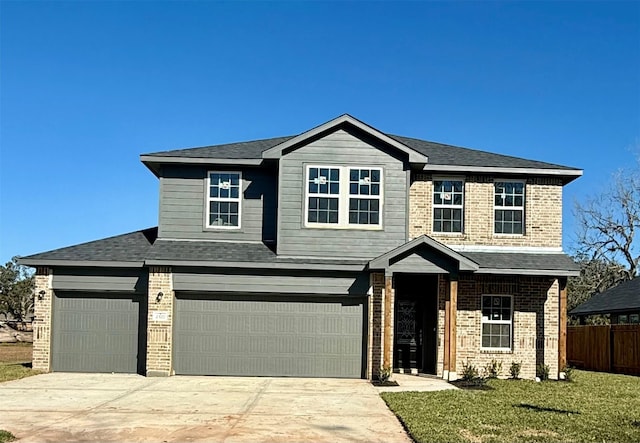 view of front of home featuring a front yard and a garage