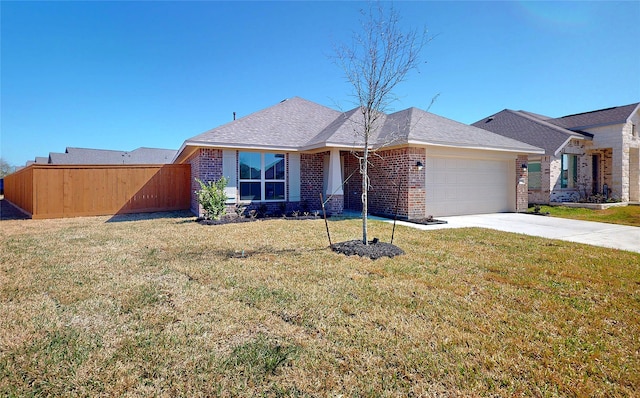 view of front of property with a garage, brick siding, fence, driveway, and a front yard