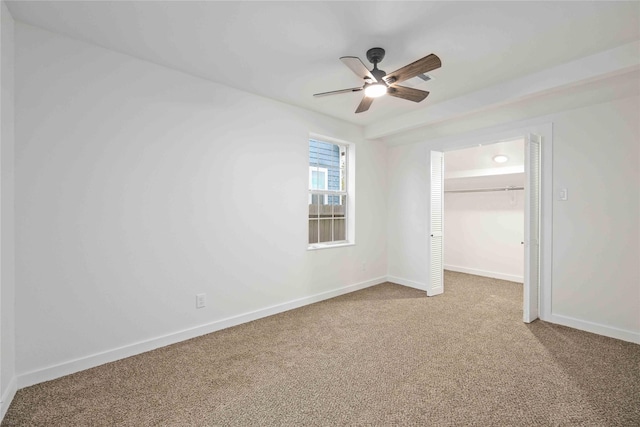 unfurnished bedroom featuring ceiling fan, light colored carpet, and a closet