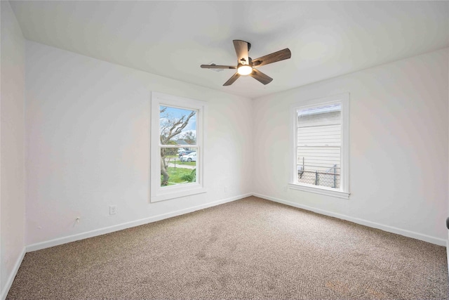 empty room featuring carpet flooring and ceiling fan