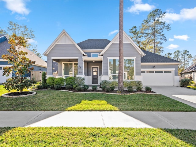 view of front of property featuring a porch, a garage, and a front yard