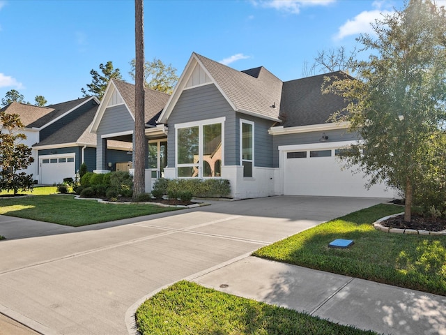 view of front of property featuring a garage and a front yard