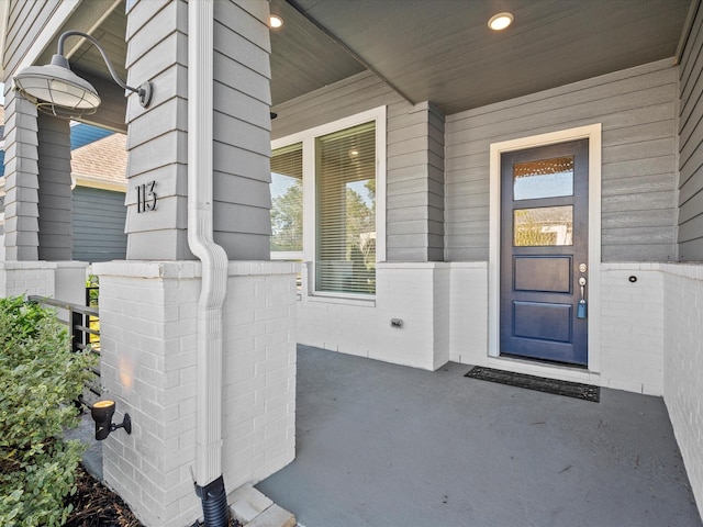 view of exterior entry with covered porch