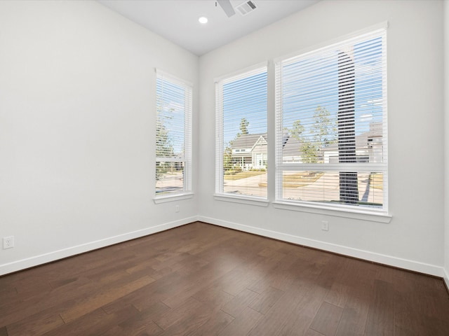 empty room featuring ceiling fan and dark hardwood / wood-style flooring