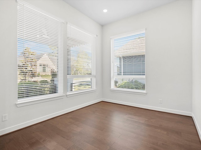 spare room with dark hardwood / wood-style floors