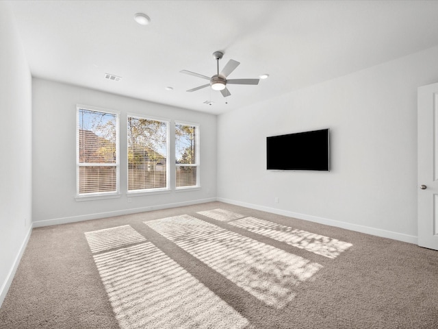 unfurnished living room with light colored carpet and ceiling fan