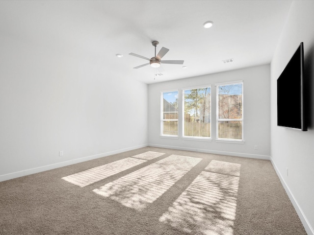 carpeted spare room with ceiling fan