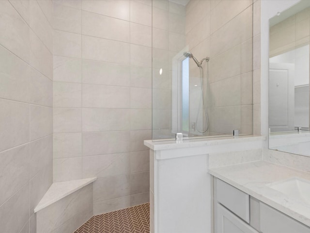 bathroom with vanity and tiled shower