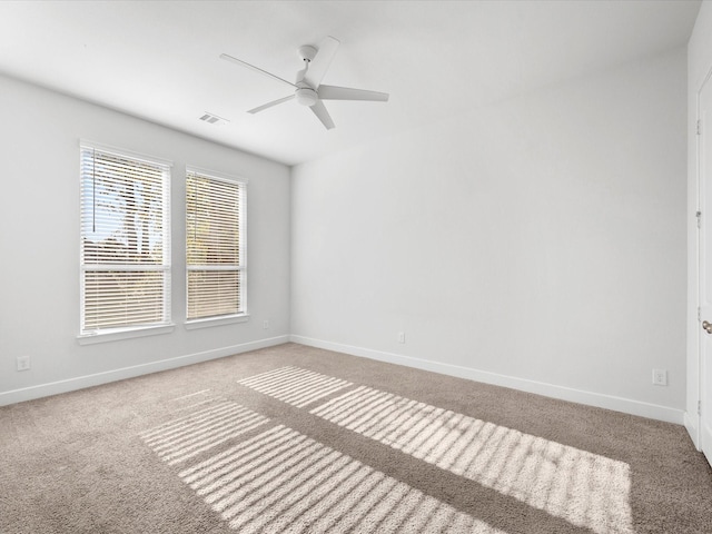 spare room featuring carpet flooring and ceiling fan