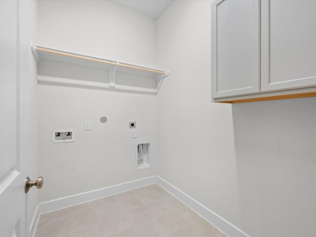 clothes washing area with washer hookup, gas dryer hookup, cabinets, and hookup for an electric dryer