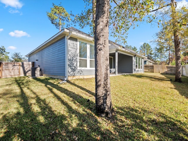 rear view of property featuring a yard