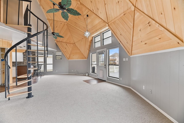 additional living space featuring carpet floors, wood ceiling, and a towering ceiling