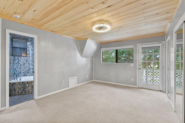 additional living space featuring carpet floors, wooden walls, and wooden ceiling