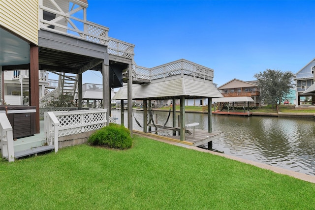 dock area with a lawn and a water view