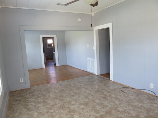 unfurnished room featuring ceiling fan, wood-type flooring, and ornamental molding