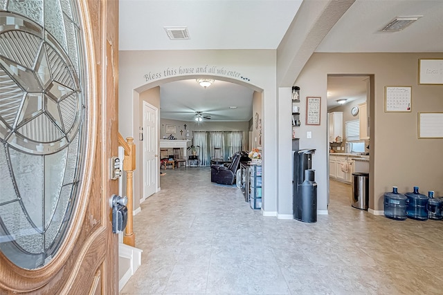 foyer entrance with ceiling fan