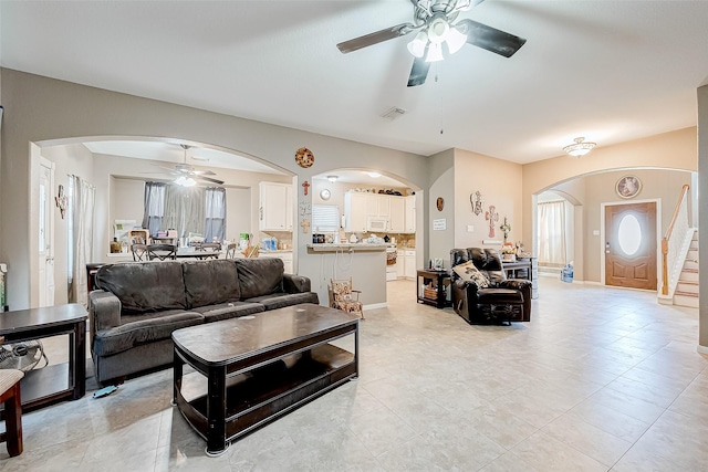 tiled living room with ceiling fan