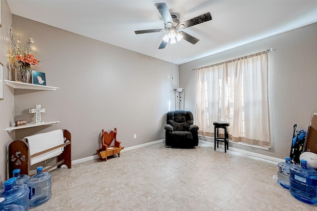 living area featuring ceiling fan