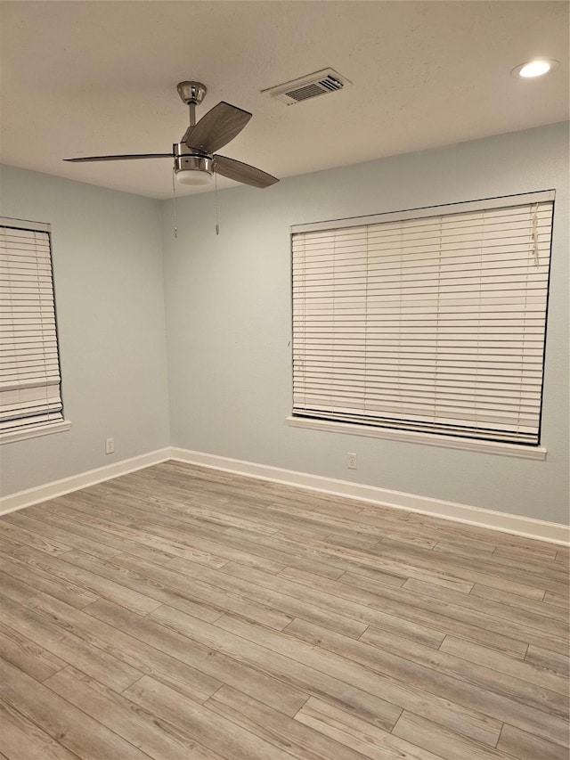 spare room with light hardwood / wood-style flooring and ceiling fan