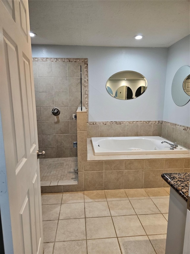 bathroom featuring tile patterned flooring, vanity, and independent shower and bath