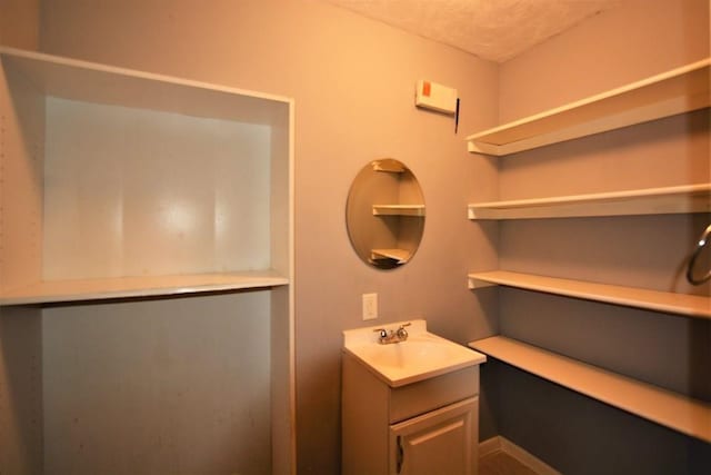 bathroom featuring a textured ceiling and vanity