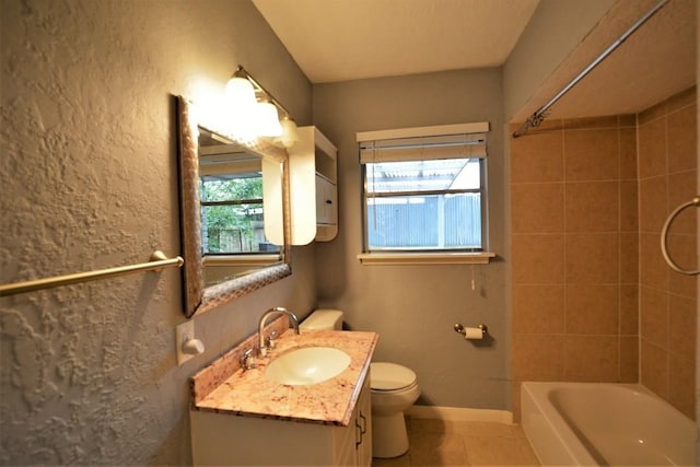 full bathroom with vanity, tiled shower / bath combo, toilet, and tile patterned flooring