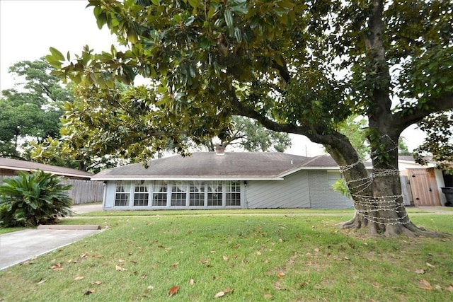 back of house with a lawn