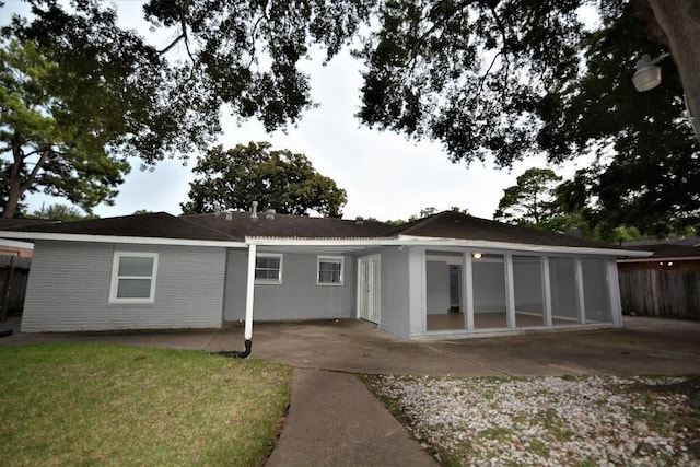 back of house with a patio area and a yard