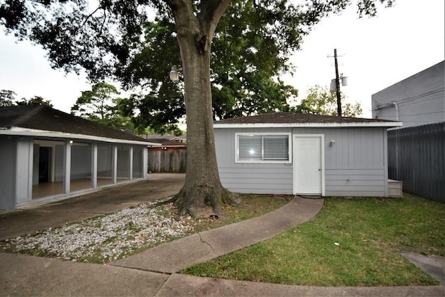 view of outbuilding with a lawn