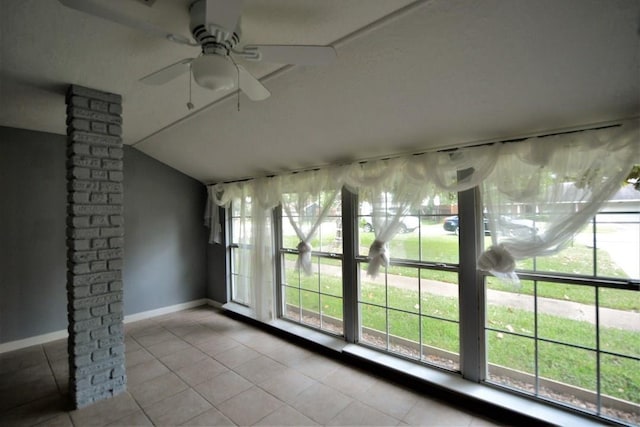 interior space with ceiling fan, light tile patterned flooring, and vaulted ceiling