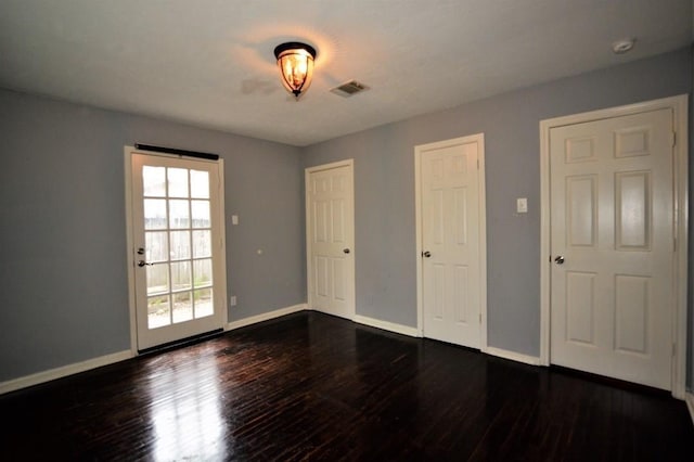 spare room with dark hardwood / wood-style flooring