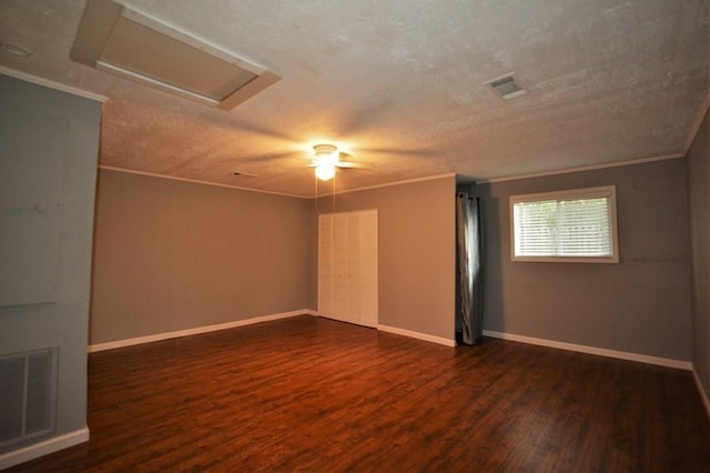 empty room featuring a textured ceiling, crown molding, ceiling fan, and dark hardwood / wood-style floors