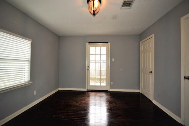 spare room featuring dark wood-type flooring