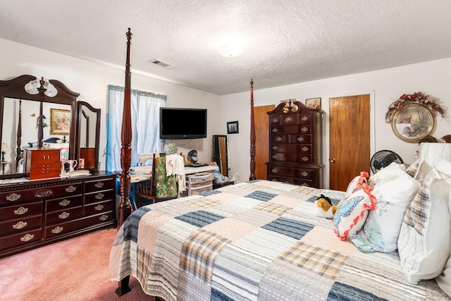 bedroom with a textured ceiling and light colored carpet