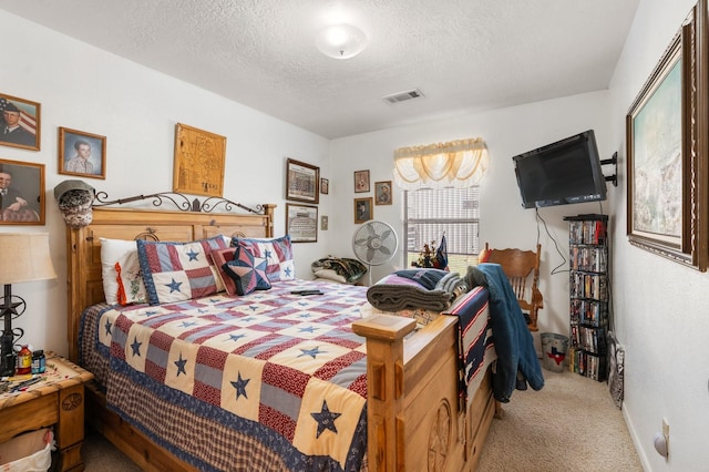 carpeted bedroom featuring a textured ceiling