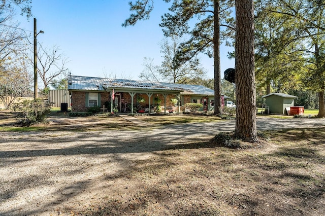 ranch-style home featuring a storage unit