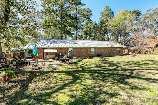 back of house featuring a patio area and a yard