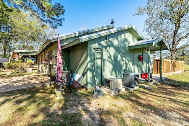 view of side of home with central AC unit and ac unit