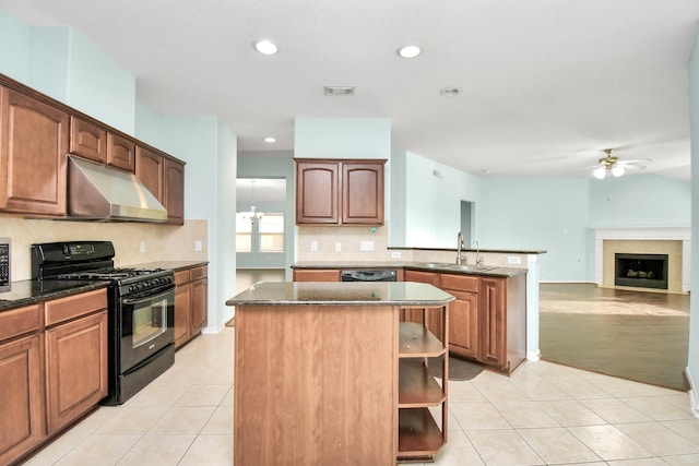 kitchen featuring ceiling fan with notable chandelier, sink, black appliances, light tile patterned floors, and a center island