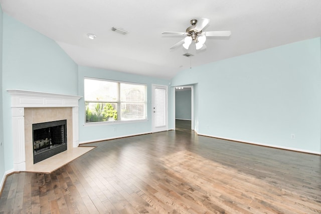 unfurnished living room featuring a tiled fireplace, ceiling fan, dark hardwood / wood-style floors, and lofted ceiling