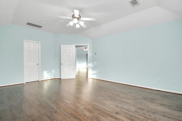 empty room with dark hardwood / wood-style floors, ceiling fan, and vaulted ceiling