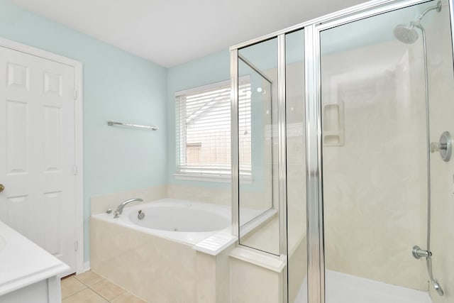 bathroom with tile patterned flooring, vanity, and shower with separate bathtub