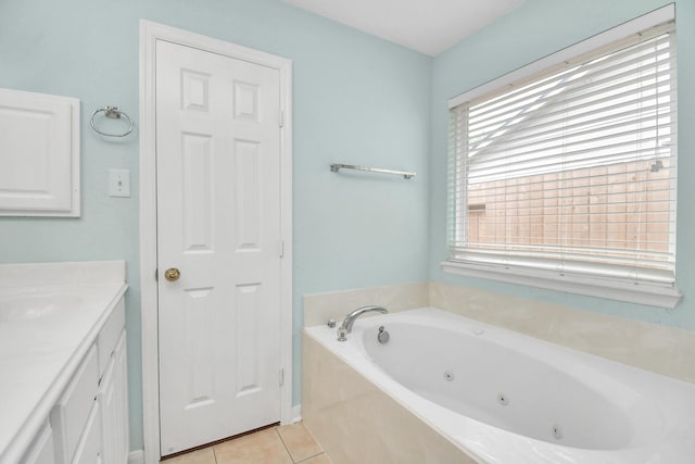 bathroom featuring tile patterned floors, vanity, a tub to relax in, and a wealth of natural light