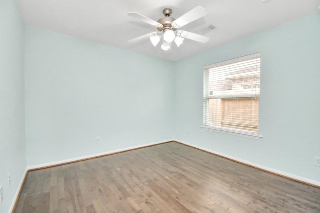 spare room with ceiling fan and wood-type flooring