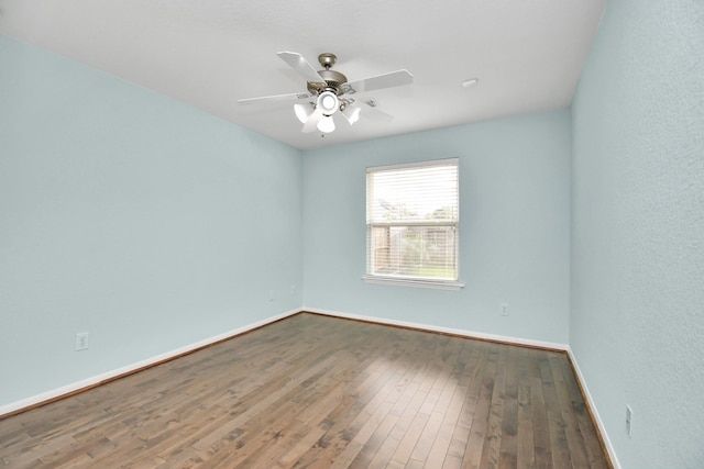 empty room featuring ceiling fan and hardwood / wood-style flooring