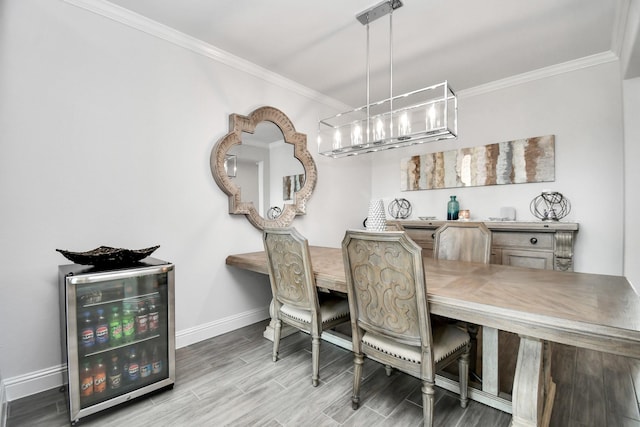 dining space with ornamental molding, beverage cooler, and light hardwood / wood-style floors